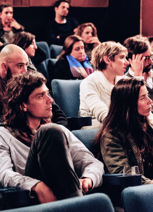 Photo showing an audience listening to a presenter